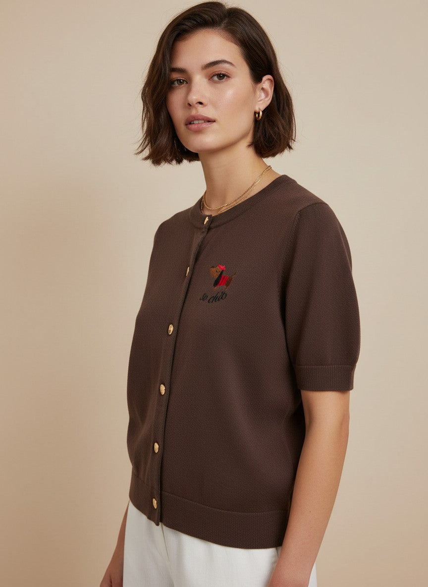 Кафява плетена жилетка Benny Boutique с къси ръкави, кръгло деколте, златисти копчета и малък бродиран детайл.