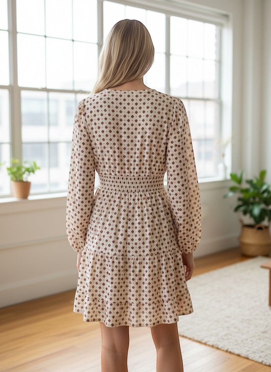 Benny Boutique cream midi dress with brown geometric print, balloon sleeves, shirred waist, and tiered skirt.