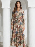 Макси рокля Benny Boutique с класическа яка, закопчаване с копчета отпред и флорален принт в маслинени, сини и земни тонове.