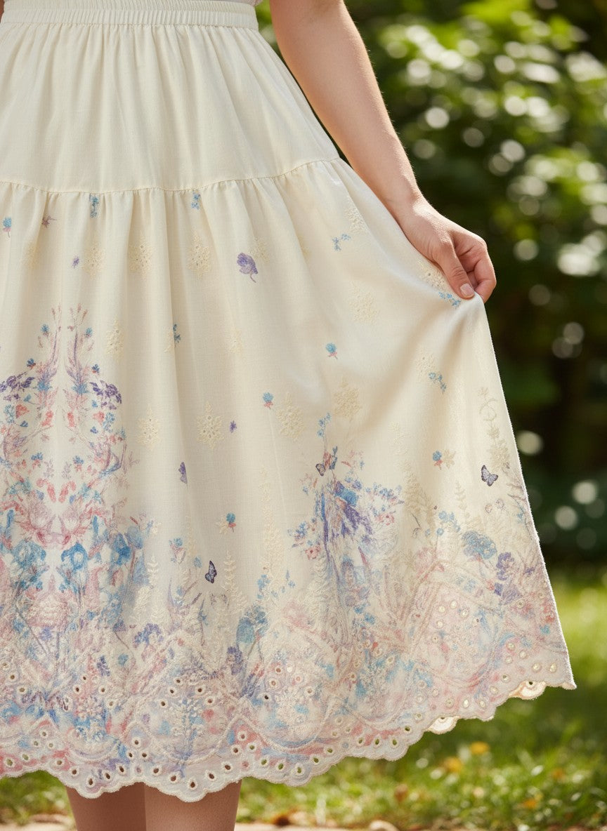 Benny Boutique макси пола в кремаво с акварелен флорален принт в синьо, розово и лилаво и бродиран детайл на подгъва.