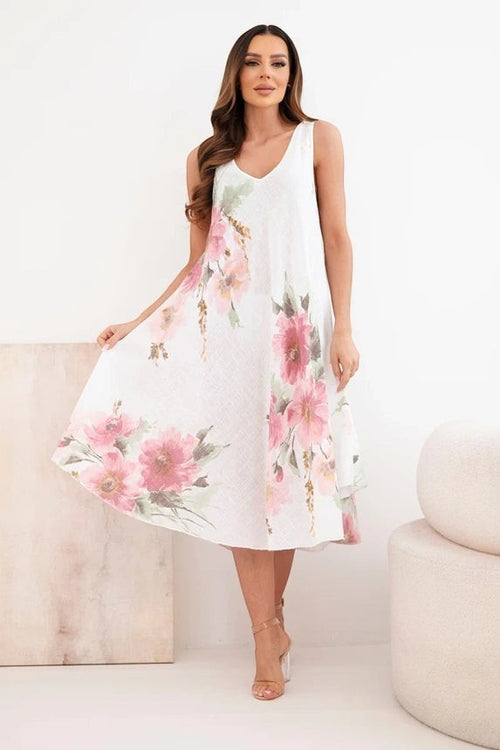 Benny Boutique бяла памучна рокля с флорален принт, асиметричен подгъв и V‑образно деколте. Перфектна за лятото.